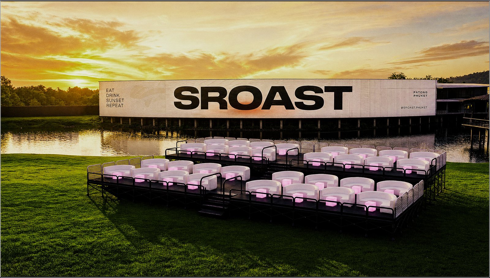 The two-tier VIP platform at sunset — white lounge sets with a pink glow, the lake and the SROAST billboard behind.